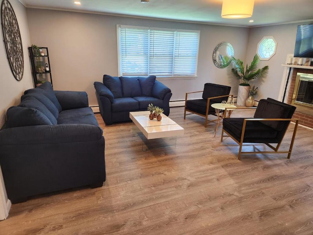 a living room with blue couches and chairs at Single Level Spacious Home - A JBMB Property in Middletown