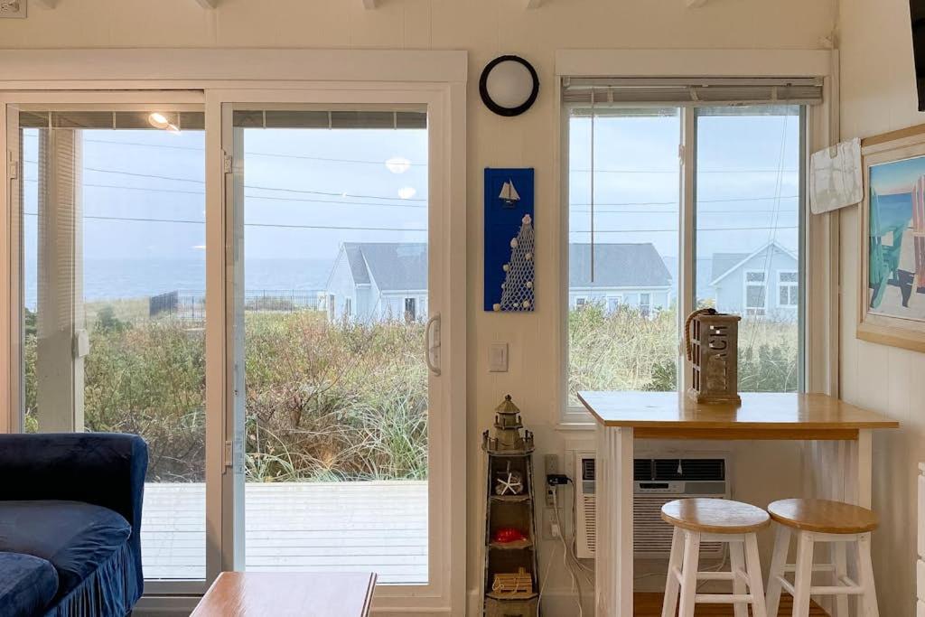 a living room with a view of the ocean at National Seashore Studio in Truro