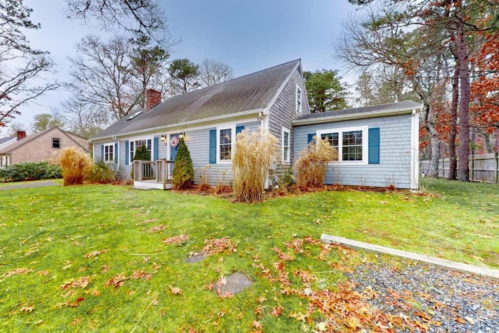 a small white house with a grass yard at Lisa Lane in Mashpee