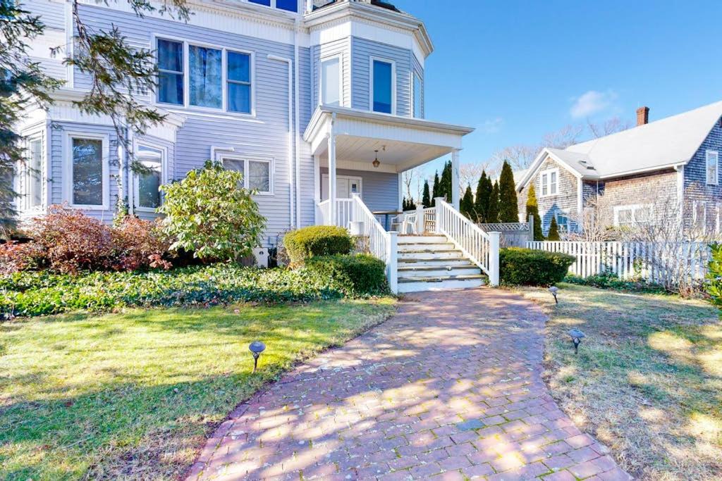 a white house with a walkway in the yard at Main Street Upper in Vineyard Haven