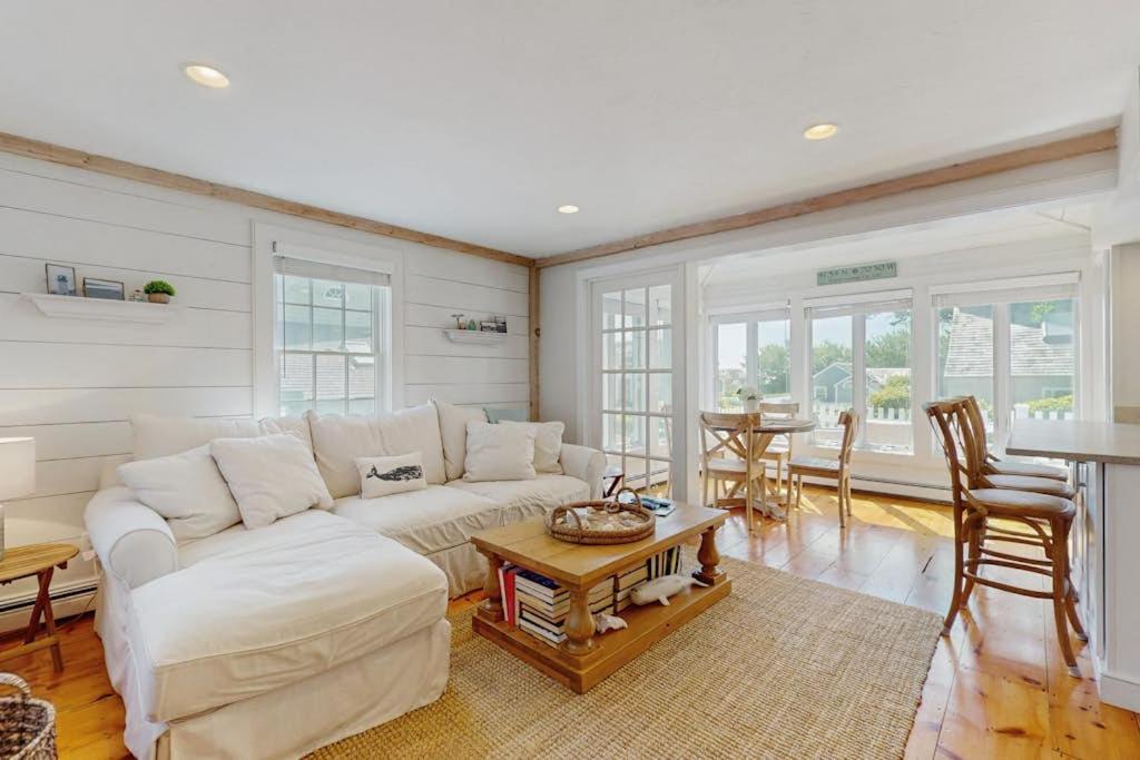 a living room with a white couch and a table at Shoreline Escape in Mashpee