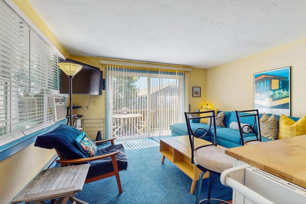 a living room with a blue couch and a table at The Blue Cottage in Provincetown
