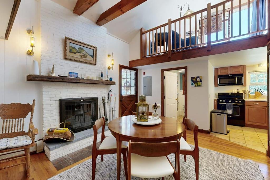 a living room with a table and a fireplace at The Lodge in Provincetown