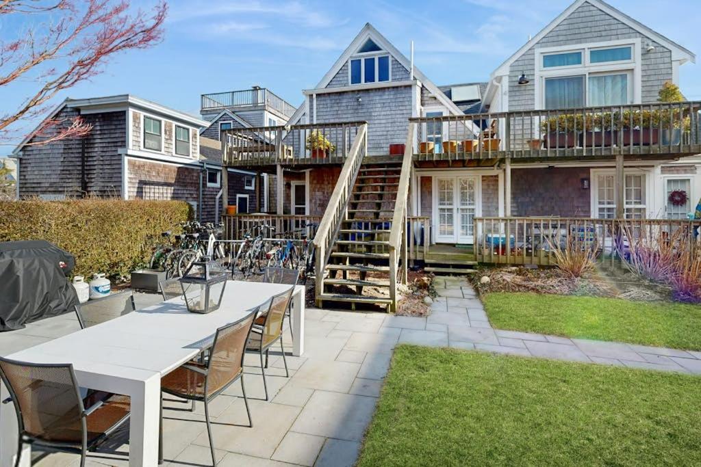 a house with a patio with a table and chairs at The Buoy Room in Provincetown
