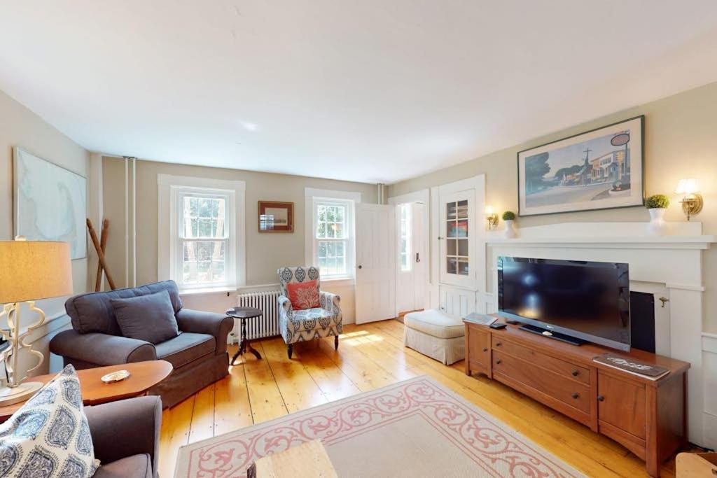 a living room with a large flat screen tv at Gray Gables in Orleans