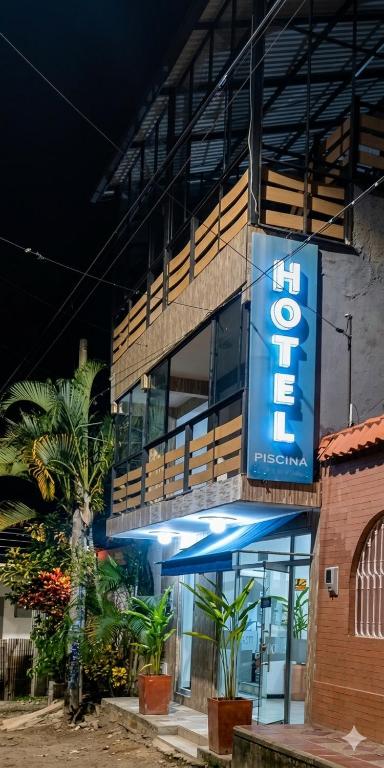 a building with a blue sign on the side of it at Hotel Casa Palma in La Mesa