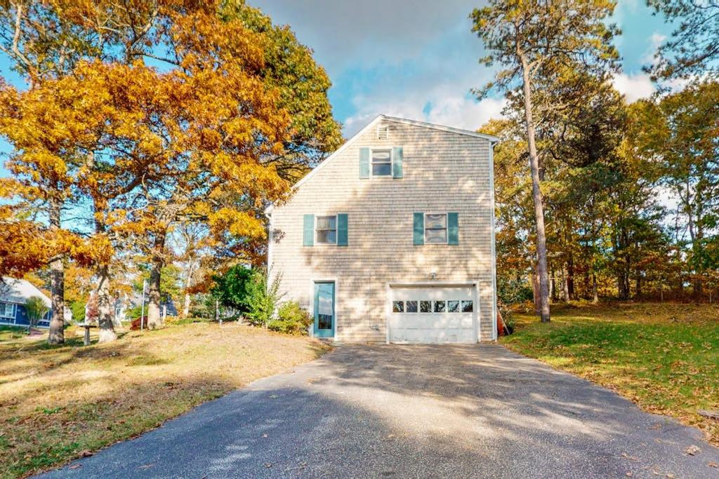 a house with a garage on the side of a road at Bay Pointe Bungalow in East Falmouth