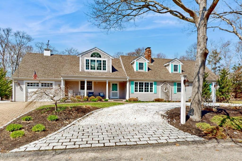 a white house with a tree and a driveway at Cape Bliss in Yarmouth