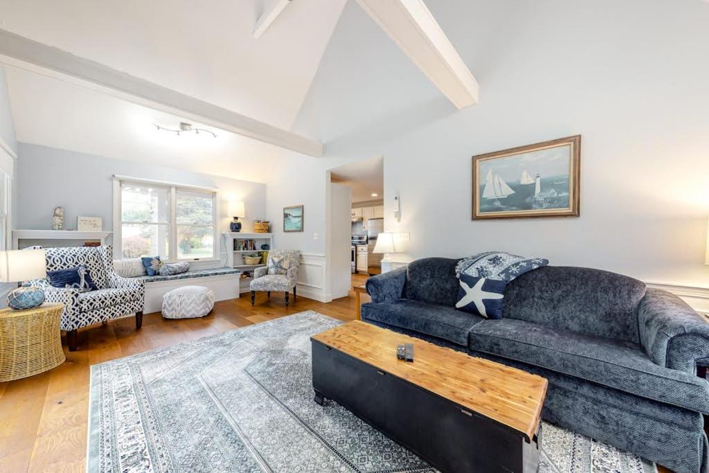 a living room with a couch and a table at Ferry Harbor Cottage in Falmouth