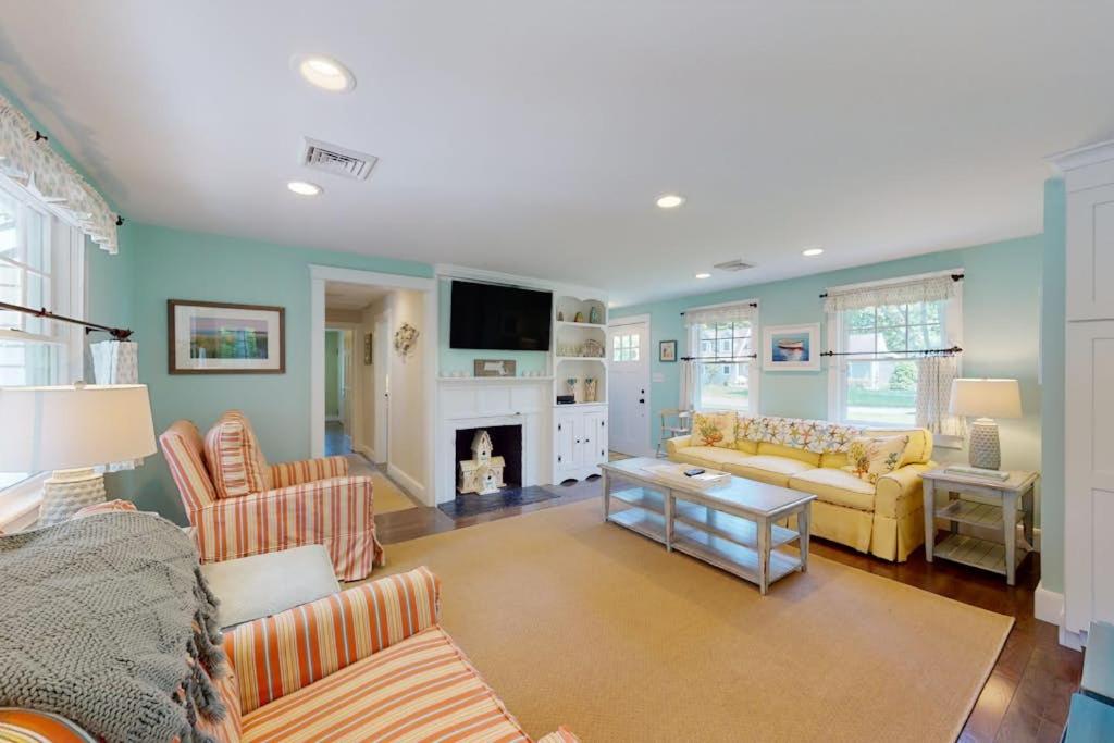 a living room with a couch and a fireplace at Cape River Retreat in Centerville