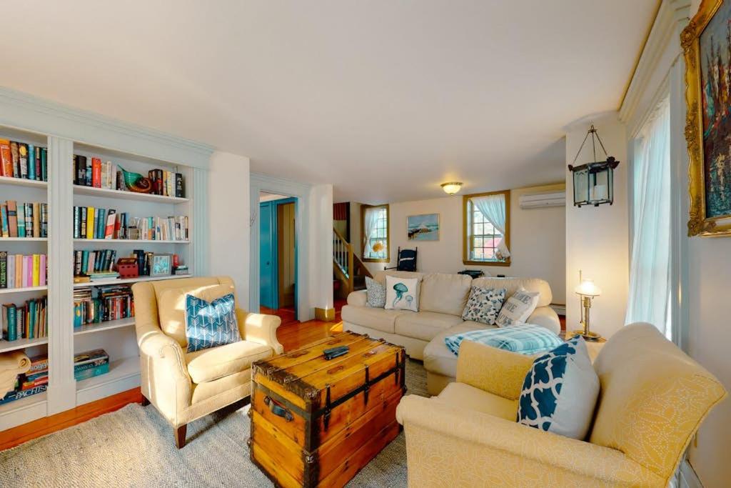 a living room with a couch and chairs and a table at Salty Ridge Station in Orleans
