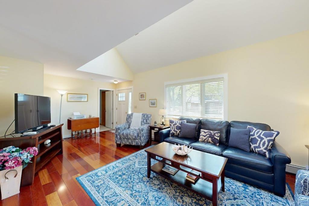a living room with a couch and a table at Set Sail in Oak Bluffs