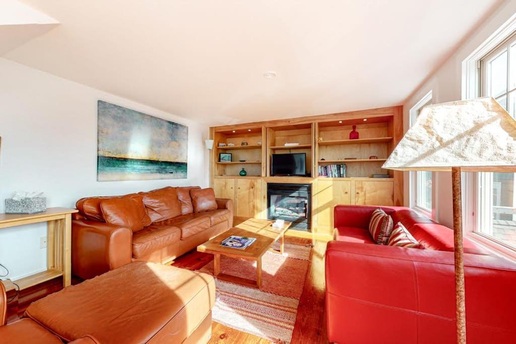 a living room with a couch and a table at Cape Point Escape in Provincetown