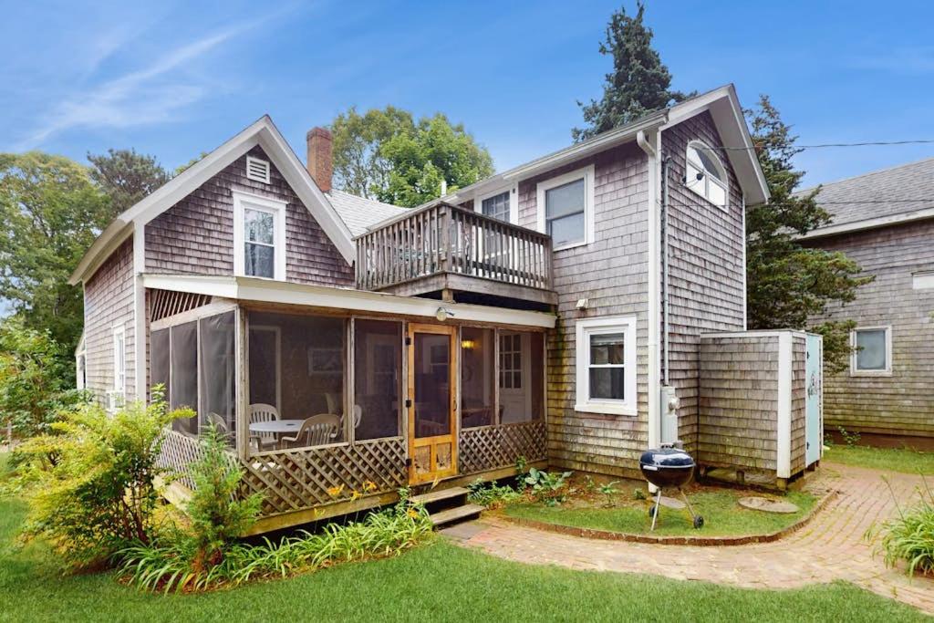 a large house with a deck and a patio at Gingerbread Dream in Oak Bluffs