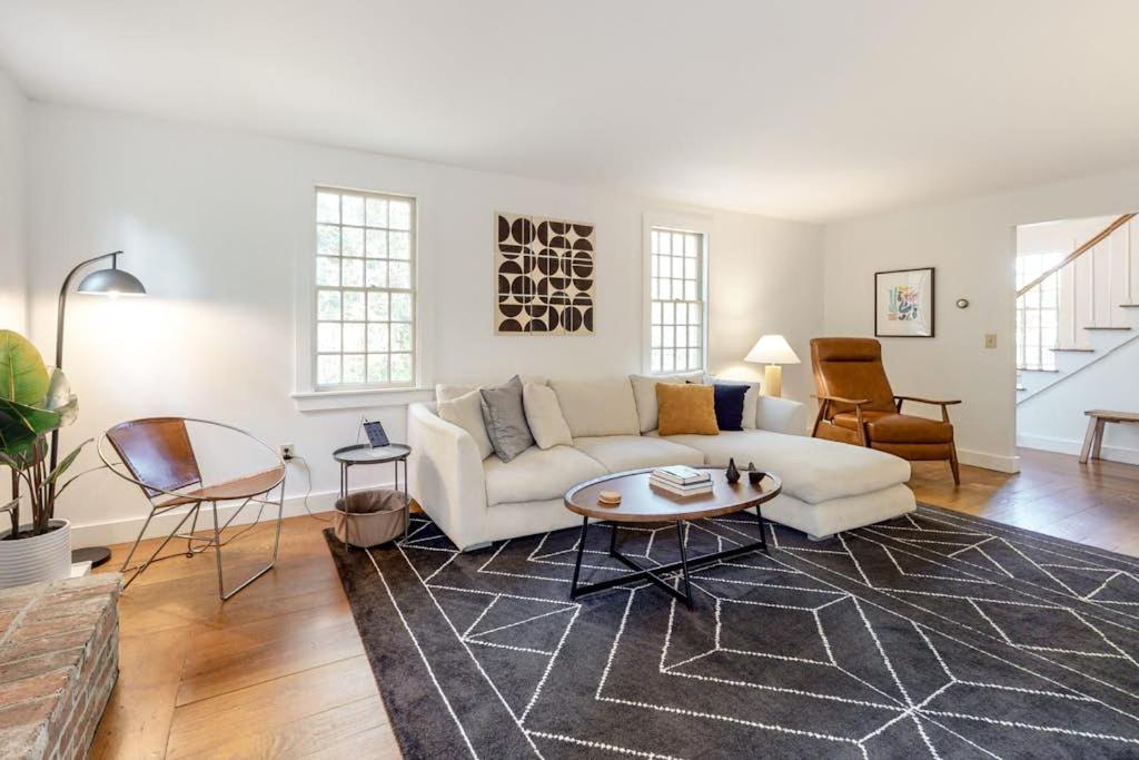 a living room with a white couch and a table at Wellfleet Harbor Hideaway in Wellfleet