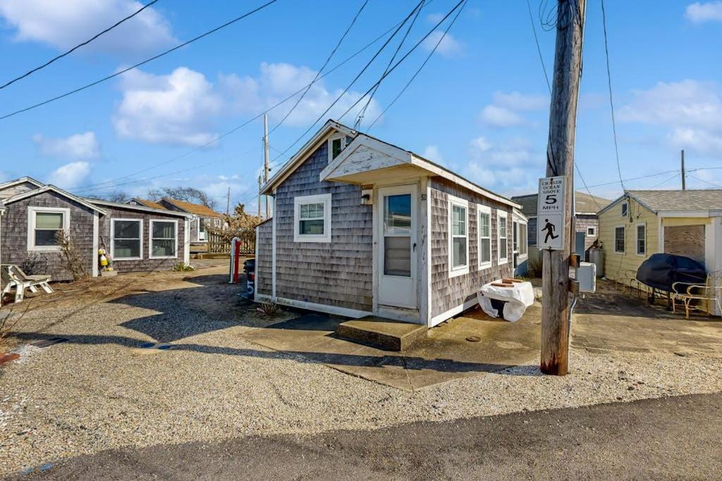 a small house sitting on the side of a street at Beach Days in Dennis Port