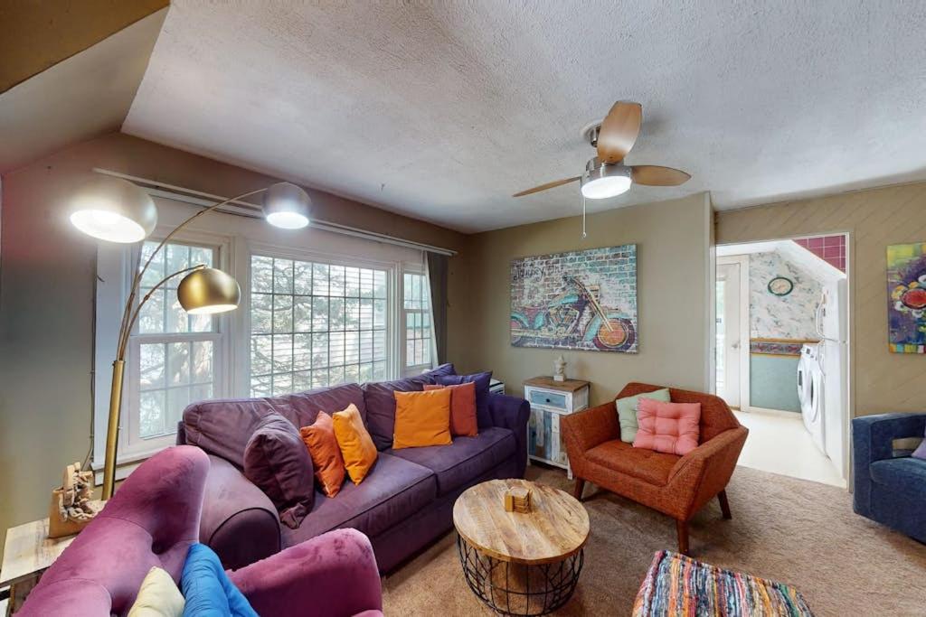 a living room with a purple couch and a table at Provincetown Bliss in Provincetown