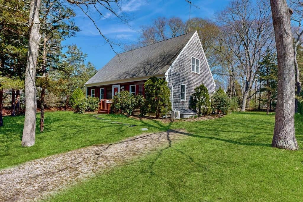 an old red barn with a green yard at Peace & Serenity in Falmouth