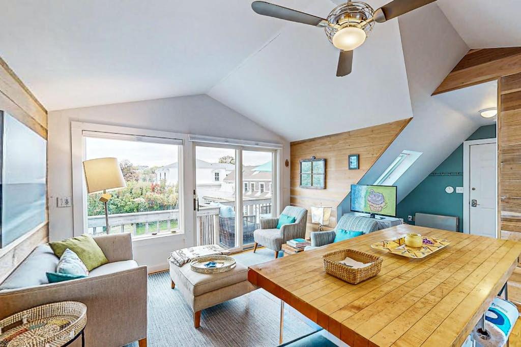 a living room with a table and a couch at Bayview Bliss in Provincetown