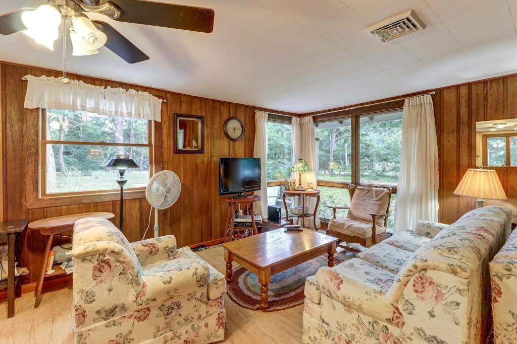 a living room with two couches and a table at Eastham Escape in North Eastham