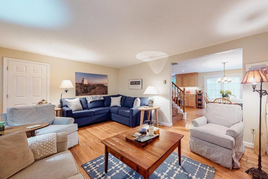 a living room with a blue couch and a table at Island Oasis in Edgartown