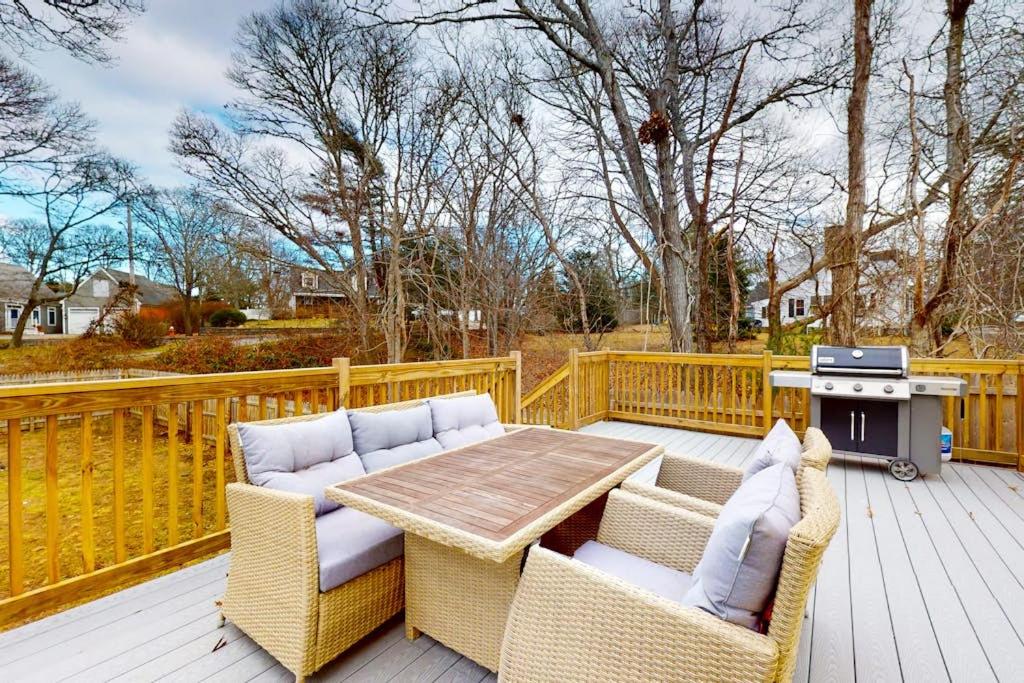 a patio with a table and chairs and a grill at Golden Slumbers in Bourne