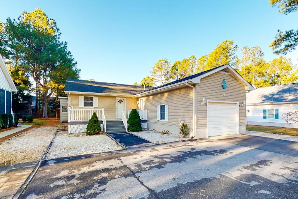 a house with a garage and a driveway at Stop And Relax in Ocean Pines