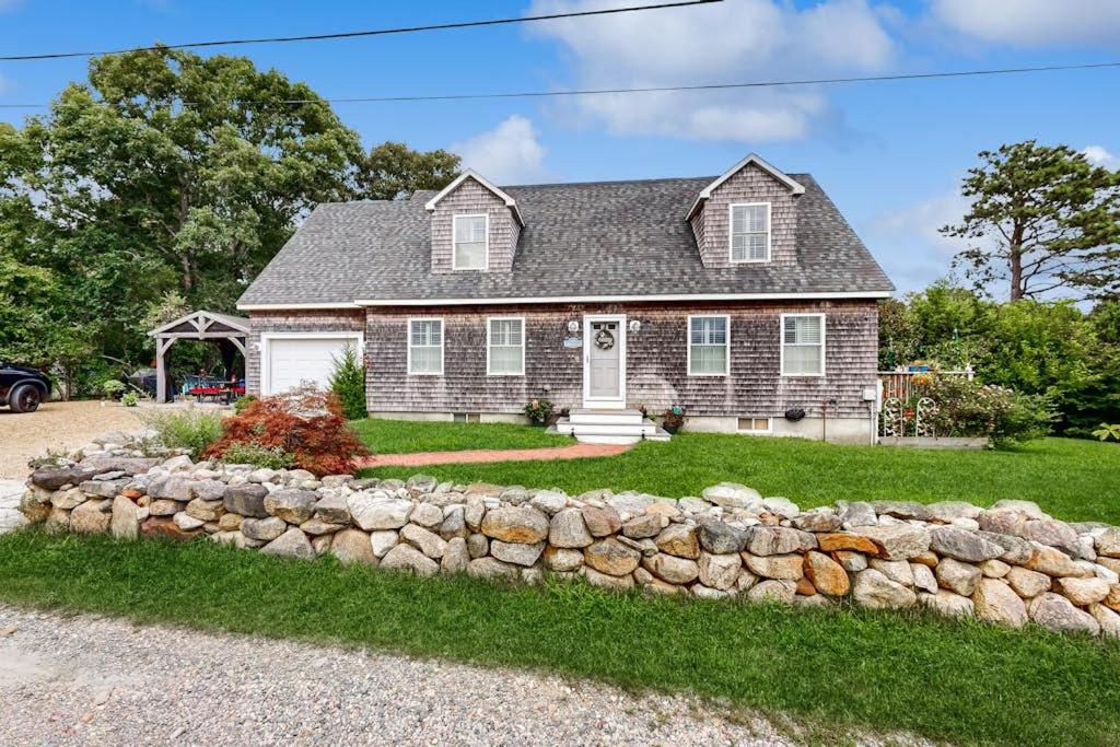 a house with a stone wall at Bird Street Breeze in Oak Bluffs