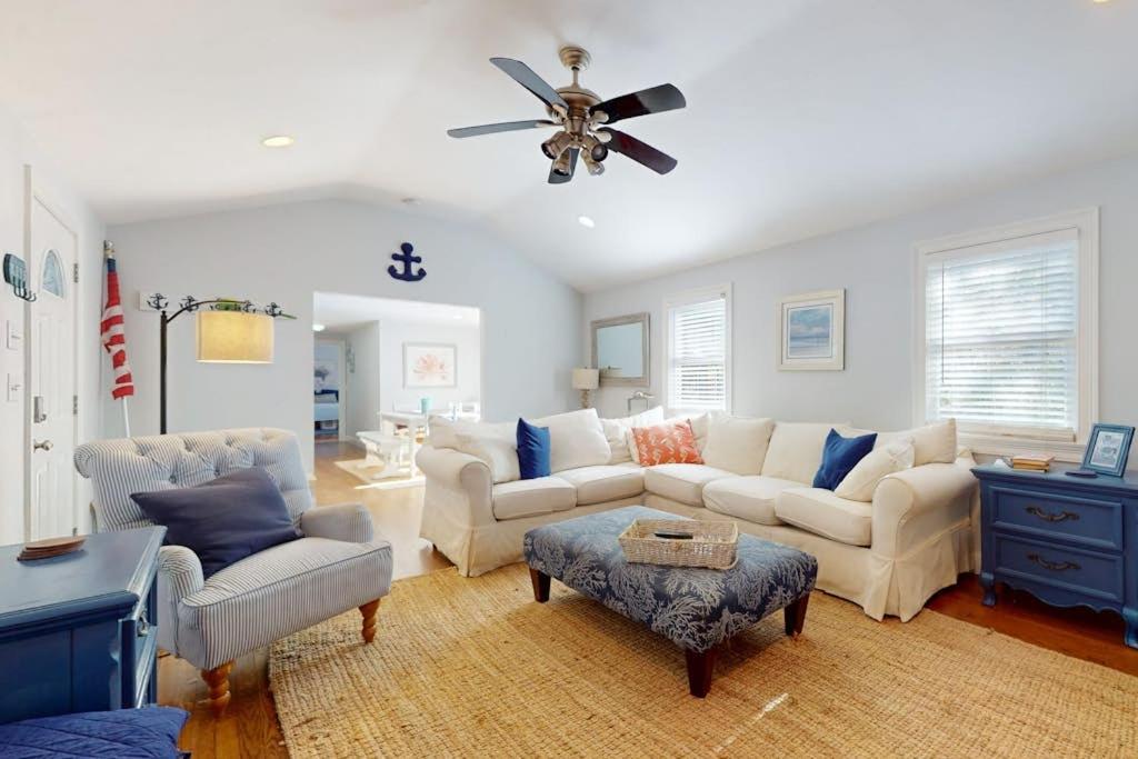 a living room with couches and a ceiling fan at Briarcliff Bliss in Barnstable