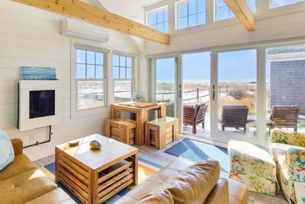 a living room with a couch and a tv at Seas The Day in North Truro