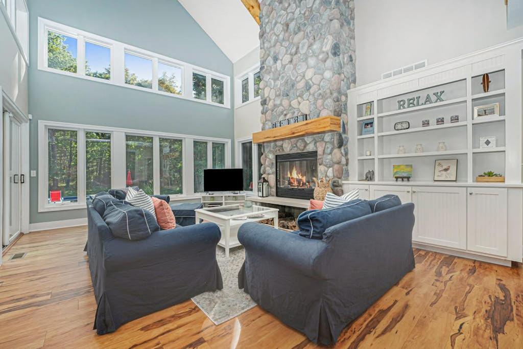 a living room with two chairs and a fireplace at Thunder Road in Fennville