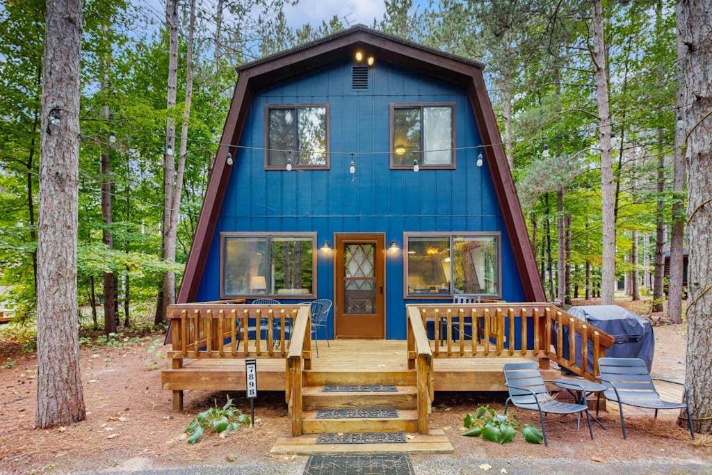 a blue house in the middle of the forest at Crystal Chalet in Thompsonville