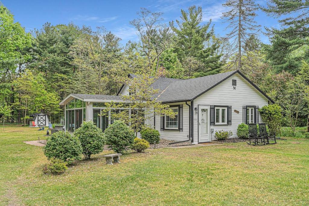 a small house in a field with a yard at Tower Hill Cottage in Sawyer