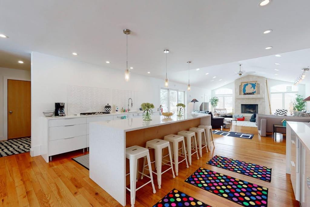 a kitchen with a counter and a bar with stools at Downtown Hideaway in New Buffalo