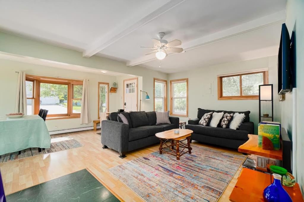 a living room with a couch and a table at Carol's Cottage in Empire