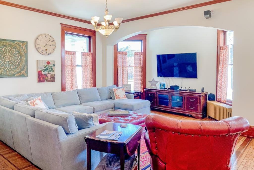 a living room with a couch and a tv at The Blacker House in Manistee