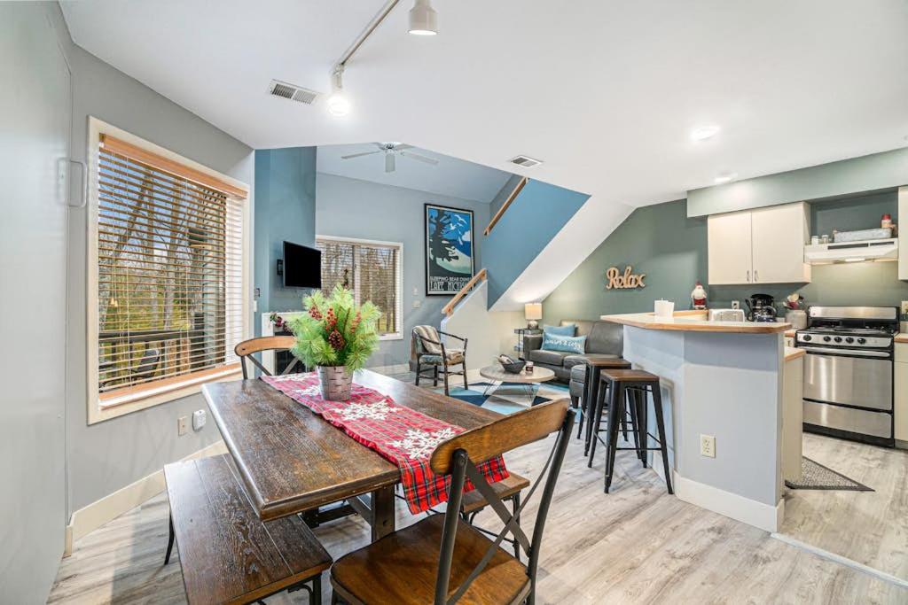 a kitchen and living room with a table and chairs at Wintergreen Condo, Unit #543 in Thompsonville
