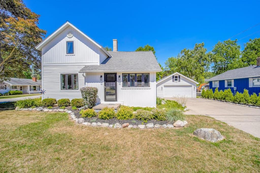 a white house with a driveway at Harbor Charm in Harbor Springs