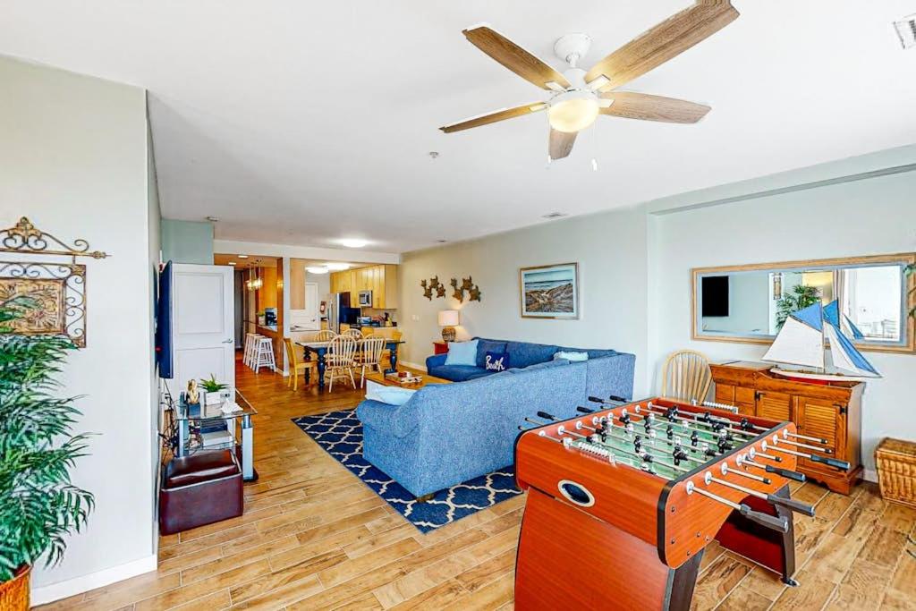 a living room with a couch and a foos ball at The Sanctuary - Summer Breeze A114 in Virginia Beach