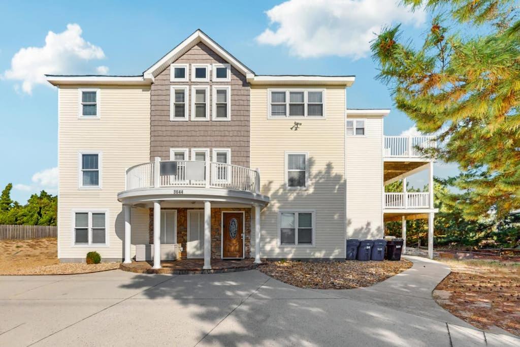 a large white house with a balcony at Down By The Sea in Virginia Beach