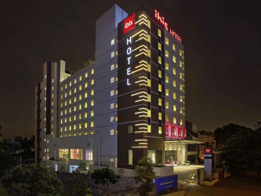 a building with a lit up sign on top of it at ibis Bengaluru City Centre - An Accor Brand in Bangalore