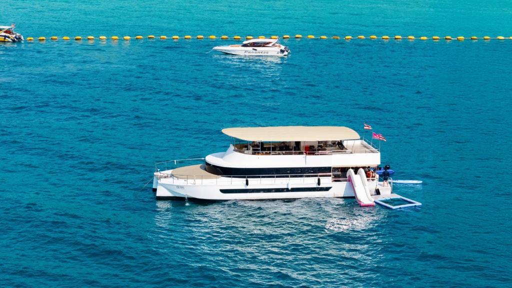 two boats floating on the water in the ocean at Ocean Odyssey in Na Jomtien