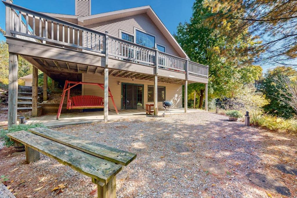 a house with a deck and a bench in front of it at Ridge Wood in Empire