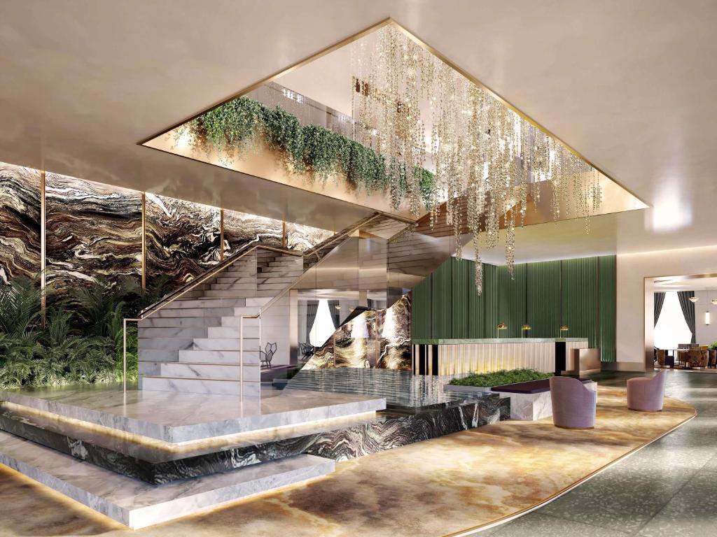 a rendering of a lobby with stairs and a chandelier at FAIRMONT NEW ORLEANS in New Orleans