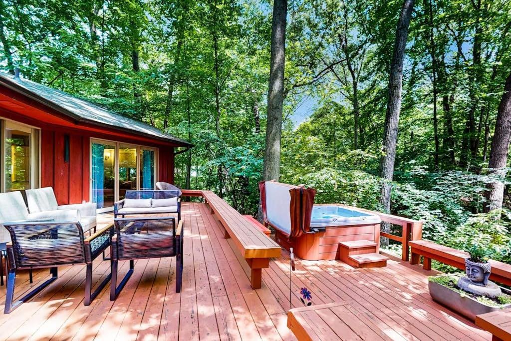 a deck with chairs and a bench on a cabin at The Tree House in New Buffalo