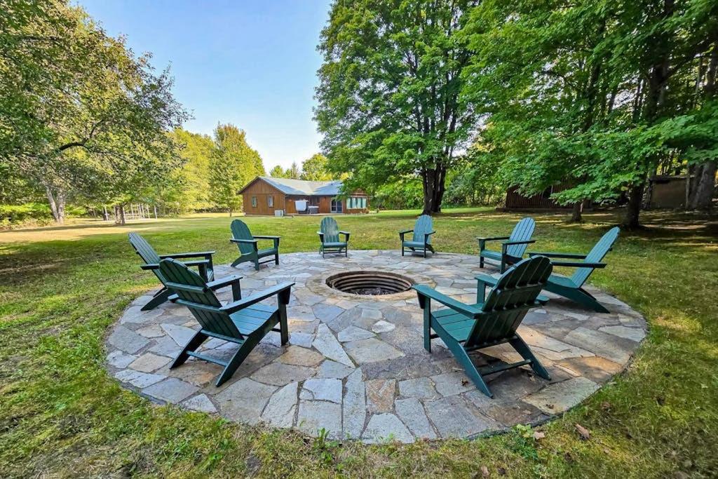 a group of chairs sitting around a fire pit at Trout Lily Cabin in Beulah