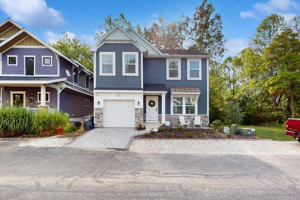 a blue house with a white garage at Wrightwood Cottage in South Haven