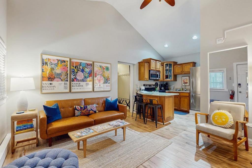 a living room with a couch and a kitchen at Arrowhead Resort - Stylish Retro Escape in Saugatuck