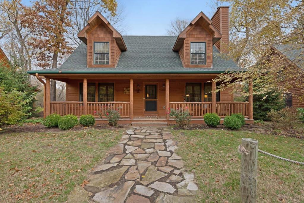 a wooden house with a stone path in front of it at Kingfisher Cove Cabin 2 in Saugatuck