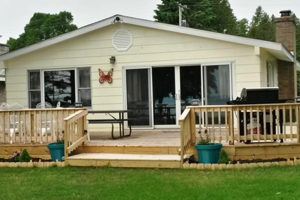 a house with a deck and a patio at The Summer House in Onekama